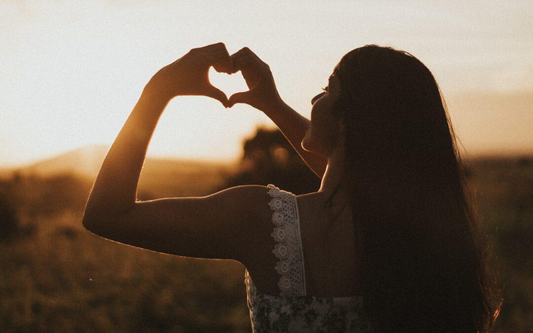 Woman with hands in heart position